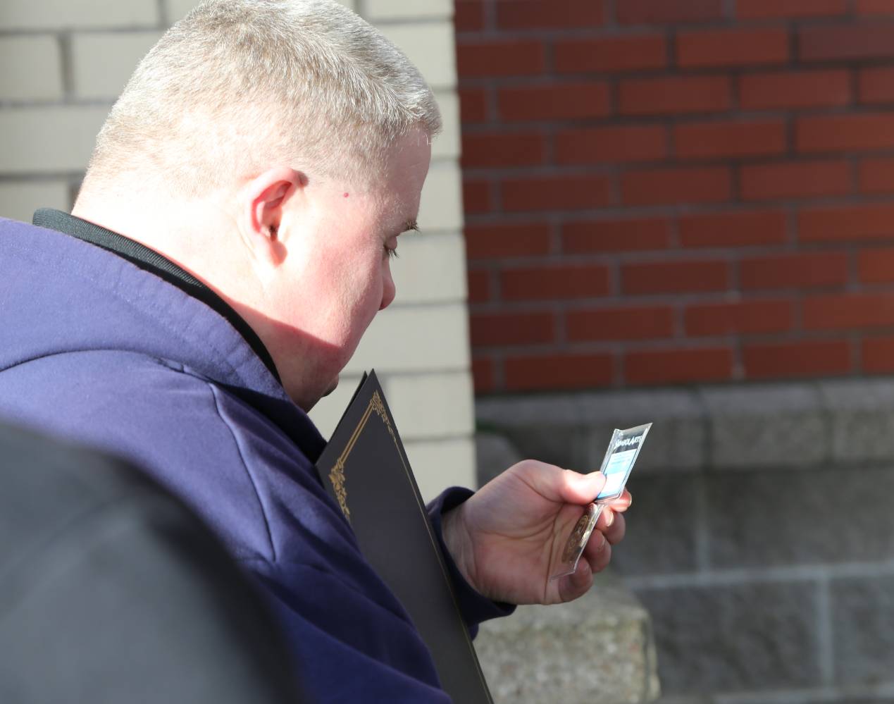 Joel examines a police challenge coin given to him by NDPD officers.